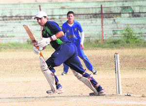 A batsman playing a shot during a match in the Eid-Divali Milan Cup tournament at MA Stadium in Jammu.