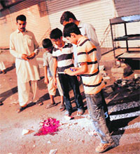 Residents gather at the site of an attack in Karachi.