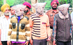 The three accused (with covered faces) were wanted in several cases of loot and drug peddling in Amritsar. photo: sameer sehal 