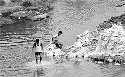 Two men wash sacks in N-chou in Mohali