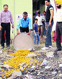 Officials destroy sweets during a raid on a sweets shop at Balongi village on Monday