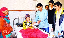 Students of Phoenix Club extend Divali greetings to one of the child patients at the PGI in Chandigarh on Monday