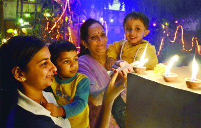 People light candles on the eve of Divali in New Delhi on Monday.