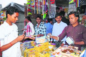 People buy Chinese crackers on the eve of Divali in Karnal on Monday
