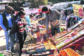 People buy crackers at a market in Shimla on Monday