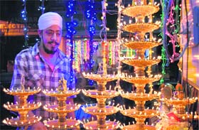A customer admires glittering electronic stuff on the eve of Divali in Jalandhar on Monday