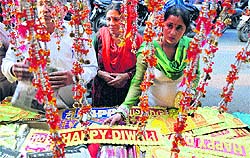 A woman selects decorative items from a stall at a market in Jammu