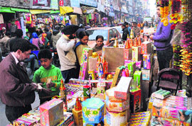 Shoppers buy crackers at a market in Srinagar on the eve of Divali on Monday.