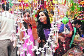 They are all set for Divali as they select items of decoration at a market in Jammu.