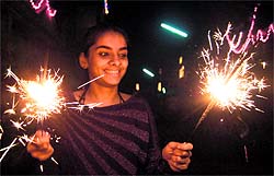 A girl is all smiles while lighting crackers in Amritsar on Tuesday night