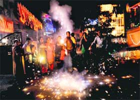 Residents celebrate the festival of lights by bursting crackers