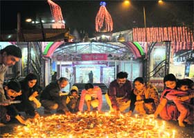 People light diyas and candles at the Laxmi Narayan temple in Sector 20, Chandigarh, on the occasion