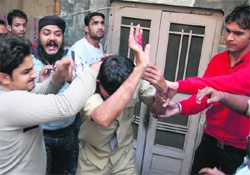 Ambala City residents thrash an under-training constable for allegedly molesting a minor girl. Tribune photograph