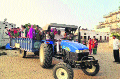 A group of 25 girl students, accompanied by four teachers and one guardian of the Lolab valley, take a round of Saraisukhi village, Kurukshetra, in a 