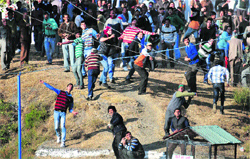 People participate in the traditional Pathar Mela near Shimla on Wednesday. Photo: Amit Kanwar