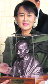 Aung San Suu Kyi with a bust of Mahatma Gandhi at Rajghat in New Delhi on Wednesday. Tribune photo: Mukesh Aggarwal