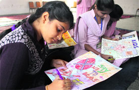 Children participate in a district-level poster-making contest held on Childrens Day in Jalandhar on Wednesday.