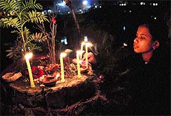 A girl lights a candle on Divali in Srinagar on Tuesday