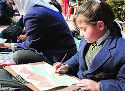 Students participate in a stamp designing competition in Srinagar on Wednesday