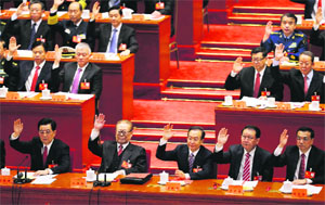 (Front row, L-R) China's President Hu Jintao, China's former President Jiang Zemin, China's Premier Wen Jiabao, Standing Committee of the Political Bureau member Li Changchun and China's Vice-Premier Li Keqiang raise their hands as they take a vote at the closing session of 18th National Congress of the Communist Party of China, at the Great Hall of the People in Beijing on Wednesday.