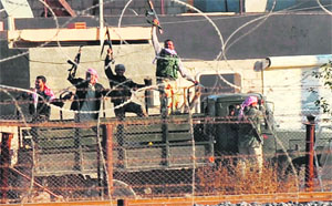 Syrian opposition fighters celebrate on the strategic Syrian border town of Ras al-Ain.