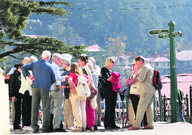 Foreign tourists enjoy the pleasant weather in Shimla on Thursday.