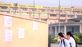 Protest slogans pasted on a wall of the institute by the staff in Jalandhar on Thursday