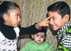 A girl applies tikka on the forehead of her brother on the occasion of Bhai Dooj in Ludhiana on Thursday.
