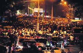 Supporters of Shiv Sena chief Bal Thackeray outside his residence in Mumbai on Wednesday night