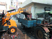 A JCB machine removes garbage in Abohar on Friday.