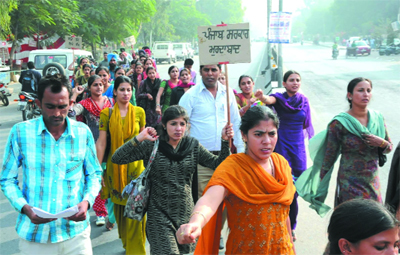 Special trainers staging a march in favour of their demands and in protest against the state government, in Bathinda on Friday. 