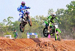 Bikers at a practice session; and (below) a biker falls during practice for the National Super Cross Championship at the Sector 17 Circus Grounds in Chandigarh on Friday