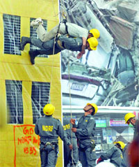 A team of the National Disaster Response Force performs a live demonstration in case of an earthquake during the IITF at Pragati Maidan in New Delhi on Friday