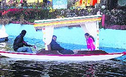Tourists enjoy a ride in a shikara at Company Garden in Mussoorie.