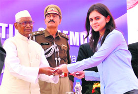 Governor Jagannath Pahadia gives a scholarship to a student at ITM University in Gurgaon on Friday.