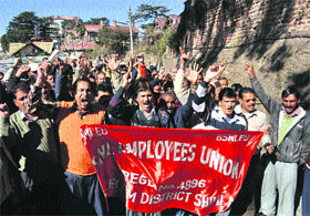 Members of the BSNL Employees Union raise slogans for their demands in Shimla on Friday.