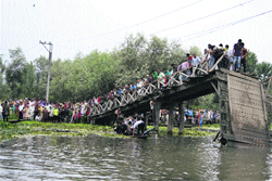 The collapsed wooden bridge over the Dal Lake in Srinagar. A tribune file photo