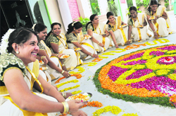 Women prepare rangoli during Onam celebrations in Ludhiana. A File Photograph