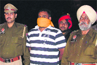 The accused in police custody in Ludhiana on Friday. Photo: Inderjeet verma