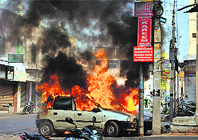 Fire of hatred: Flames and smoke rise from burning cars following violence after Friday congregational prayers in the old city area of Hyderabad on Friday. 