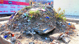 The pit covered with a base of wood and debris at Mani Majra on Saturday.