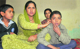 Sumit with his mother at their residence at Mani Majra on Saturday. 