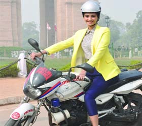 ADVOCATING HEADPIECE: Bollywood actor Sonam Kapoor wearing a helmet while riding a traffic police's motorcycle during a campaign to create awareness among women to wear helmets, at India Gate in New Delhi on Saturday