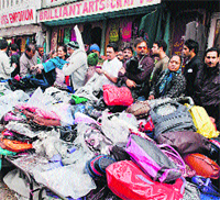 People buy woollens at the city centre Lal Chowk in Srinagar on Saturday. 