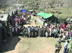 People stand in long queues to get medical check-ups at a camp in the Machhedi block of Kathua district. 