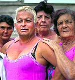 Adela Hernandez (L) poses with her neighbours in the village of Caibarien, Cuba, on Friday. She made history by becoming the first known transgender person to hold public office in Cuba