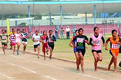 Athletes take part in a 1500-metre race at the Sports Stadium in Bathinda on Sunday