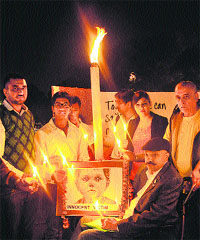 Residents light candles on World Day of Remembrance for Road Traffic Victims at the Sector-17 Plaza in Chandigarh on Sunday.