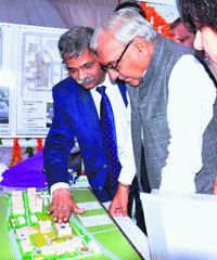 Chief Minister Bhupinder Singh Hooda has a close look at a model of Kalpana Chawla Government Medical College after laying its foundation stone in Karnal on Sunday.
