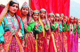 Girls in Gaddi attire await their turn to perform a folk dance a Red Cross fair in Dharamsala on Sunday.
